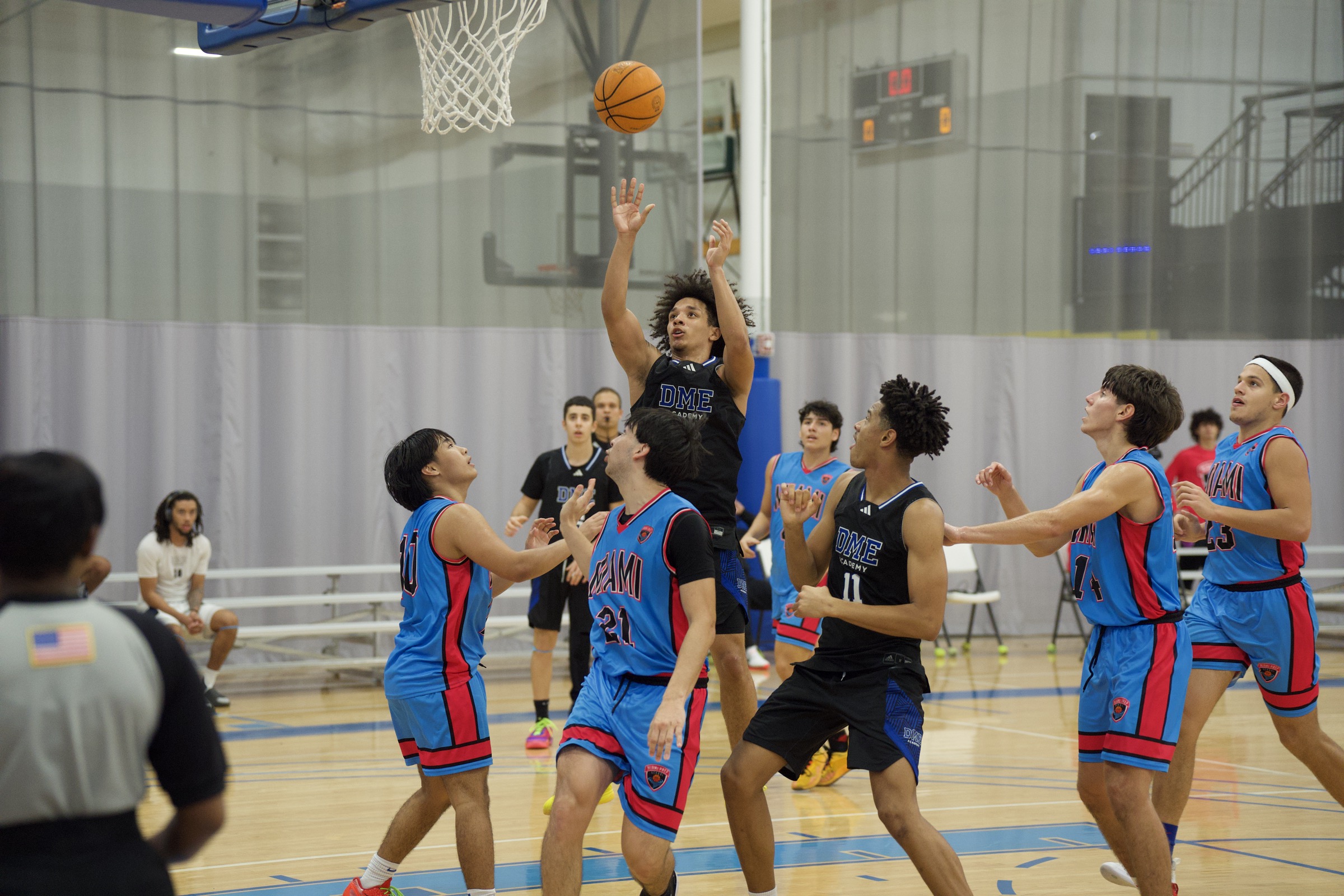 Player leaping to shoot during competitive basketball game